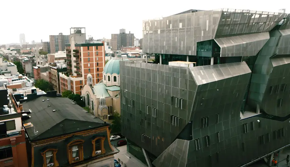 Modern Cooper Union building contrasting with older structures