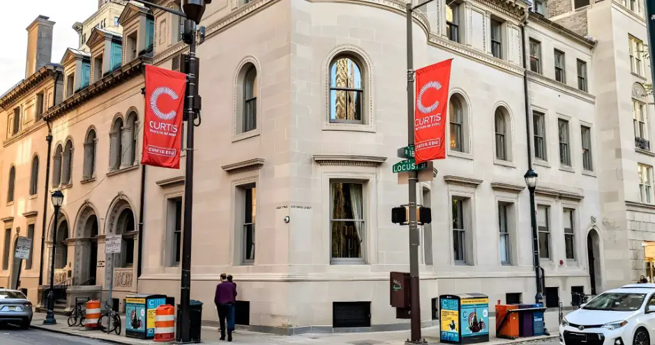 The Curtis Institute of Music, a prominent institution, stands out on a city street corner