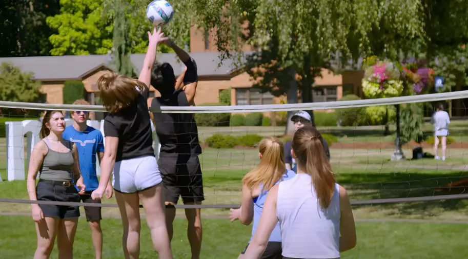 Students engage in a friendly volleyball competition