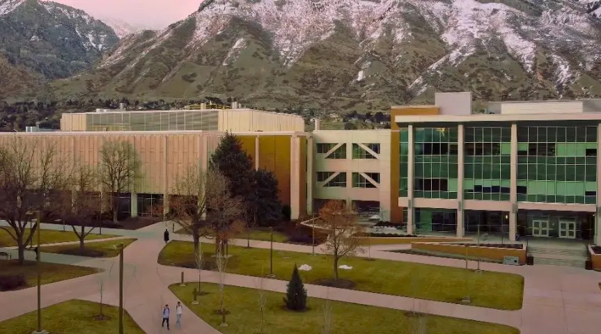 A sprawling BYU campus, nestled against a backdrop of snow-capped mountains